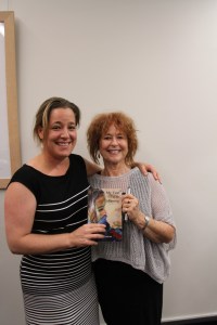 mother and daughter with book and signing pen