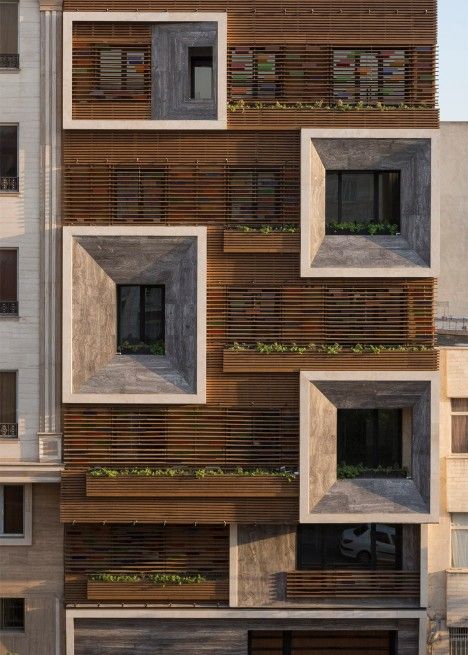 brown apartment block with faceted windows