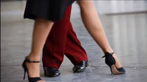 the legs of a man and a woman dancing tango