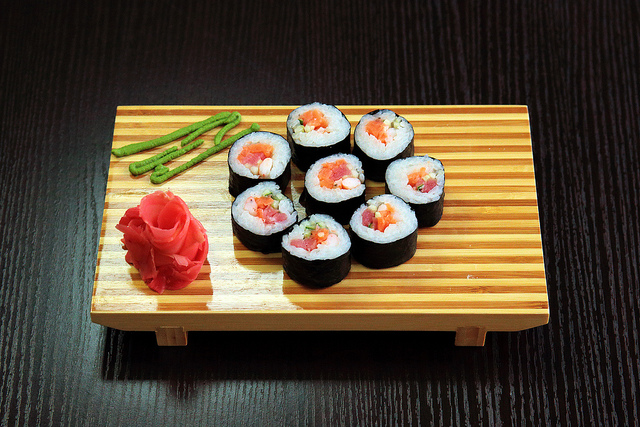 sushi rolls displayed on wooden platter