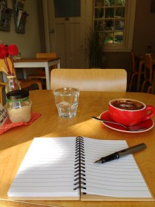 notepad, fountain pen, coffee on table