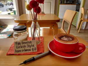pen and cup of coffee on cafe table