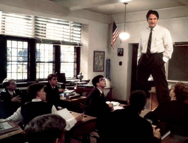 Robin Williams standing on desk in front of classroom of boys