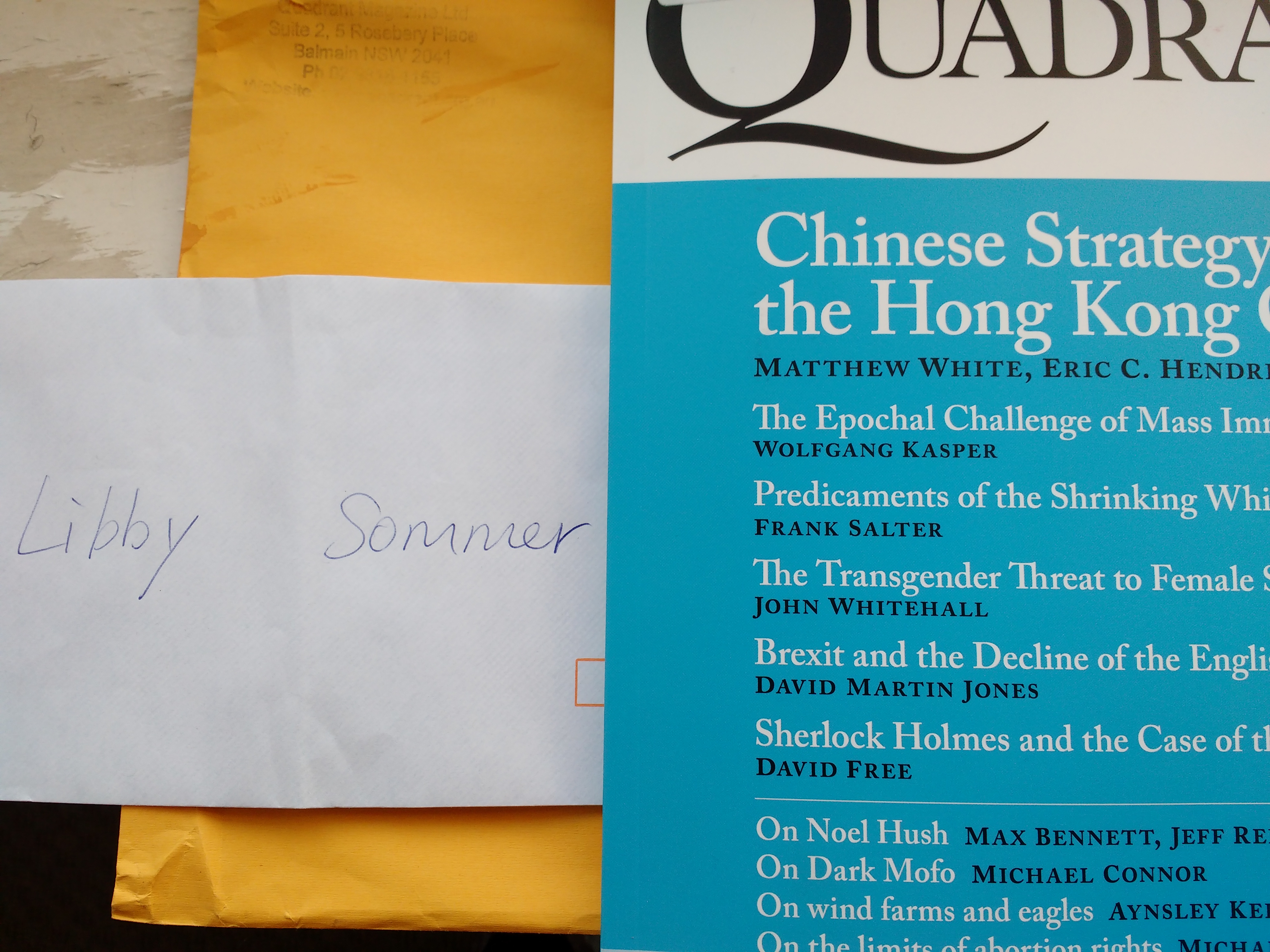 white envelope beside blue Quadrant September 2019 magazine cover